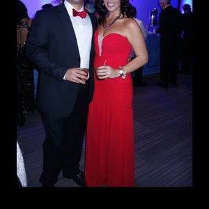 Long sleeveless red gown with ruffle detailing